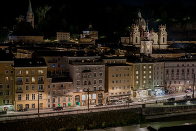 High angle view of buildings in city at night