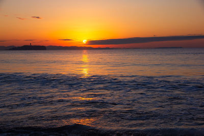 Scenic view of sea against orange sky