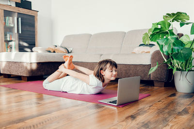 The child practices and learns yoga at home. the girl is training. sports in children's lives. 