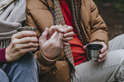 Couple sitting together with holding hands