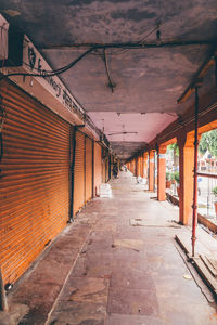 Empty narrow corridor along buildings