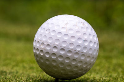 Close-up of golf ball on grassy field