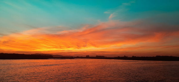 Scenic view of sea against romantic sky at sunset