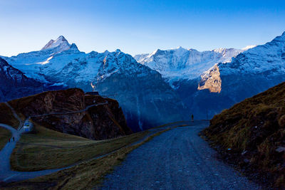 Scenic view of snowcapped mountains against clear blue sky