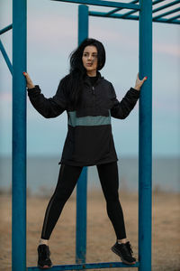 Portrait of young woman standing in playground