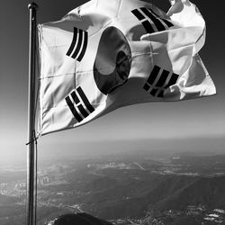 Low angle view of flags against mountain range