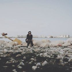 Woman sitting on rock