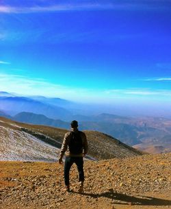 Full length of man standing on mountain against sky