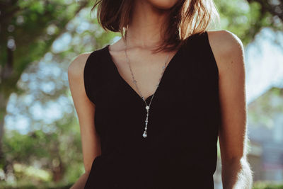 Midsection of woman standing against blurred background