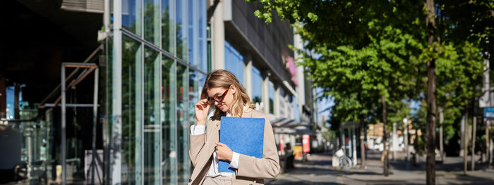 Portrait of young woman using mobile phone