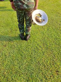 Low section of man standing on grassy field