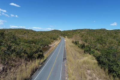 Road leading towards mountain against sky