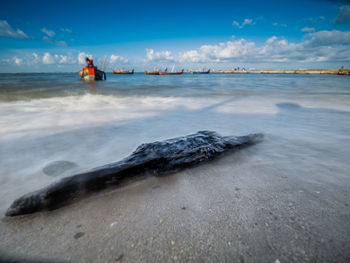 Man on beach against sky