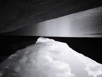 Low angle view of bridge over mountain against sky