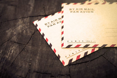 Close-up of mail envelopes on wood