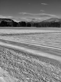 Scenic view of snowy field against sky