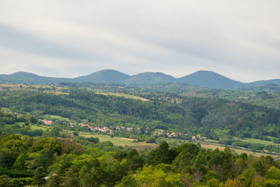 Scenic view of green landscape against sky