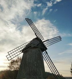 Low angle view of traditional windmill against sky