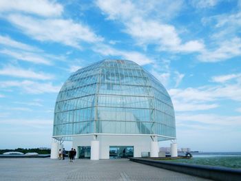 View of modern building against cloudy sky