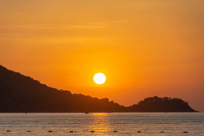 Scenic view of sea against orange sky