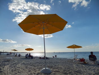 People on beach against sky