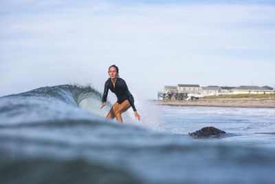 Woman surfing in rhode island summer