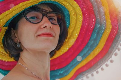 Close-up portrait of smiling woman wearing hat