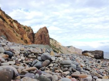 Rocks by sea against sky