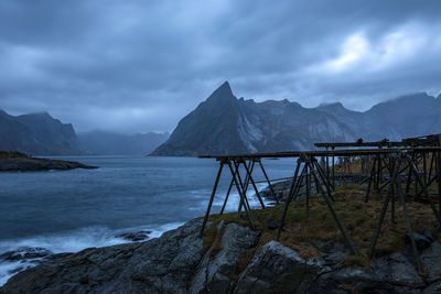 Scenic view of sea and mountains against sky