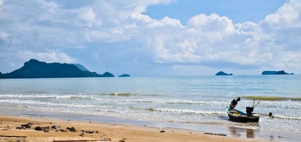 Scenic view of beach against sky on sunny day