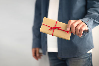 Close-up of man holding paper box