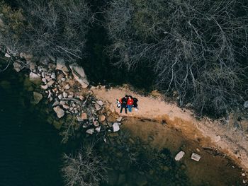 High angle view of people on rock in mountains