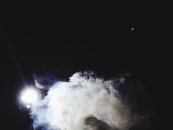 Low angle view of illuminated moon against sky at night