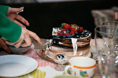 Midsection of woman preparing food on table