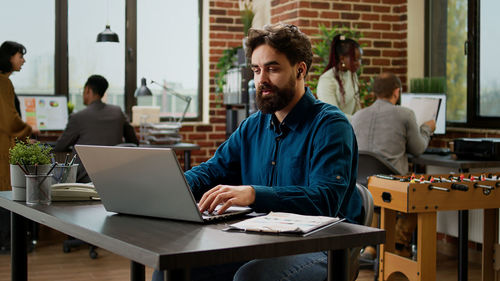 Friends using laptop at office