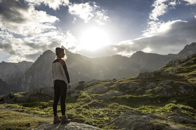 Man standing on mountain against sky