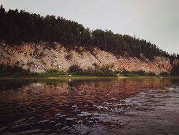 Scenic view of lake in forest against sky