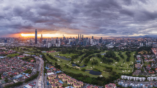 High angle view of buildings in city during sunset