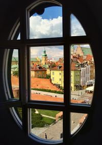 Buildings in city seen through glass window