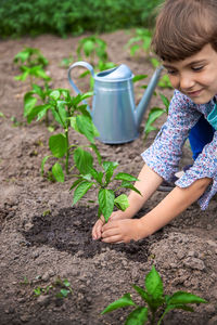 High angle view of boy holding plant