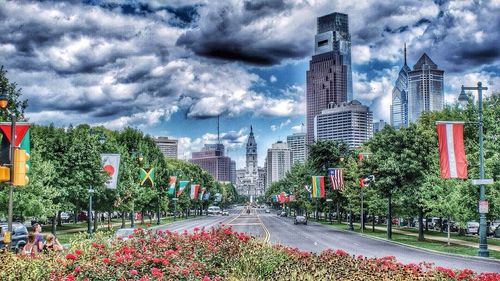 Buildings in city against cloudy sky