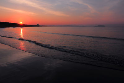 Scenic view of sea against romantic sky at sunset