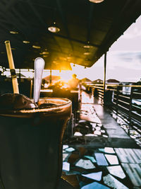 Table and chairs in restaurant at sunset