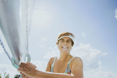 Happy senior woman spending vacation on sailboat