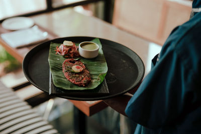 Midsection of man preparing food