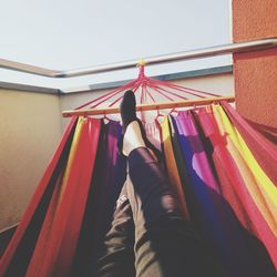 Low section of man relaxing on hammock