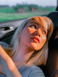 Portrait of beautiful woman in car