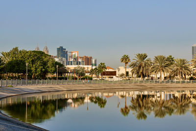 Beautiful view of the lake in dubai park against the backdrop of a modern city, travel