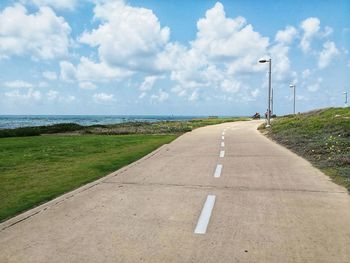 Road by sea against sky