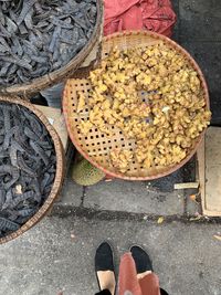 Low section of man standing by basket